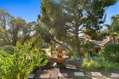 a view of a patio with couches table and chairs and potted plants