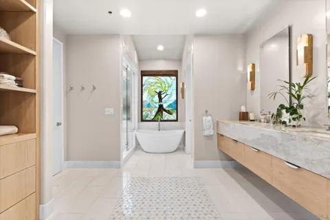 a bathroom with a granite countertop sink a toilet a mirror and bathtub