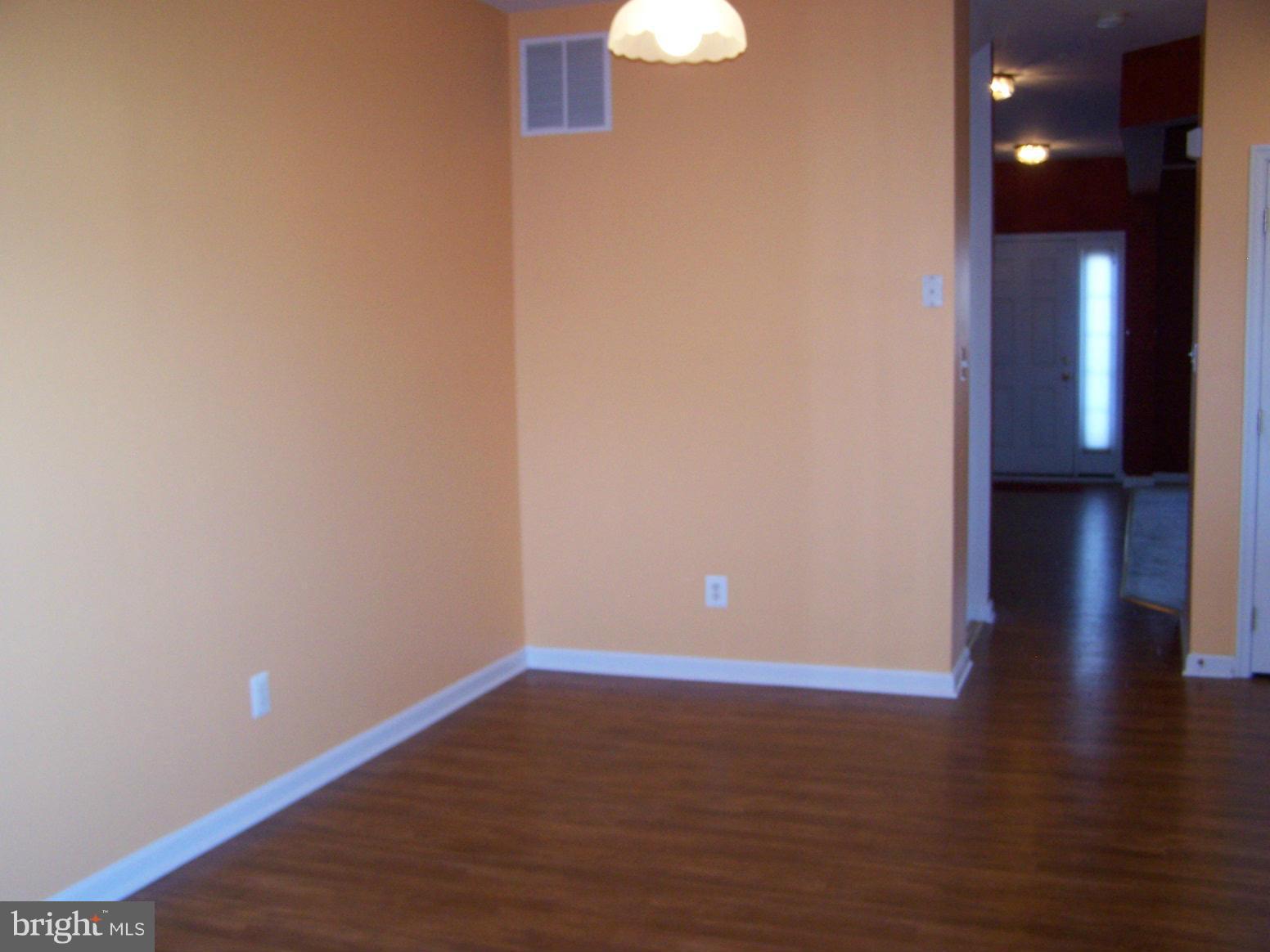 1727 Waltman Road Edgewood, MD 21040 - Photo 7 of 20 a view of an empty room with wooden floor and a ceiling fan
