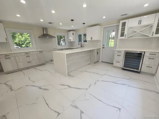a large white kitchen with cabinets