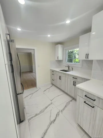 a kitchen with stainless steel appliances a sink stove and cabinets
