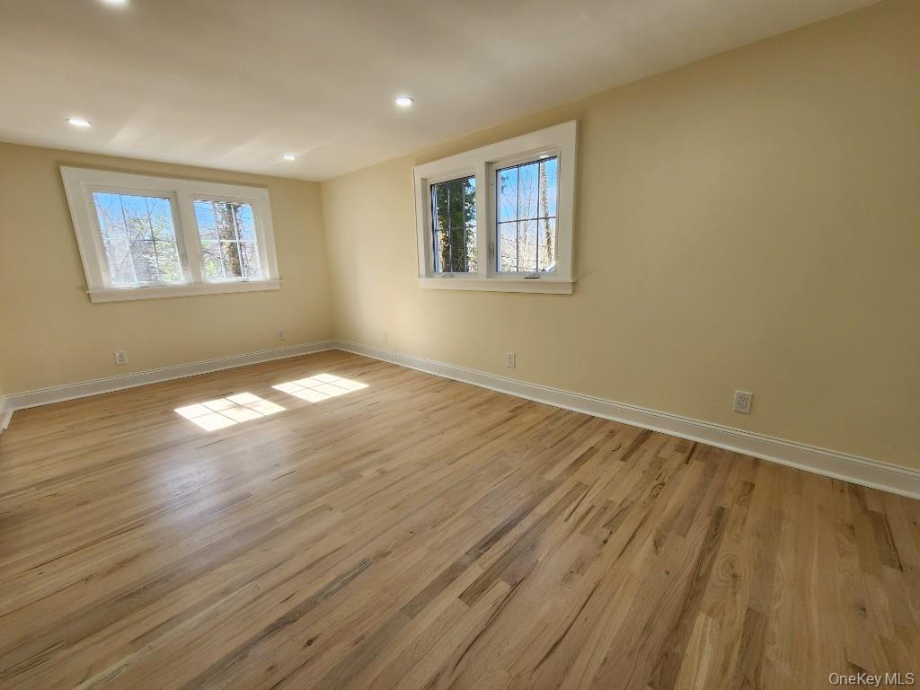 20 North Ravine Road Kings Point, NY 11023 - Photo 23 of 49 a view of empty room with wooden floor and fan