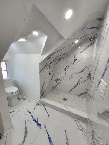 a bathroom with a toilet sink and shower