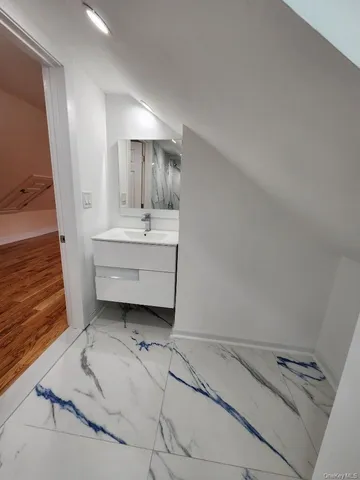 a bathroom with a sink toilet and mirror