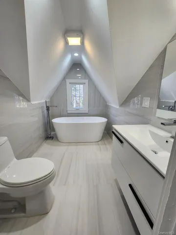 a bathroom with a sink a toilet and mirror