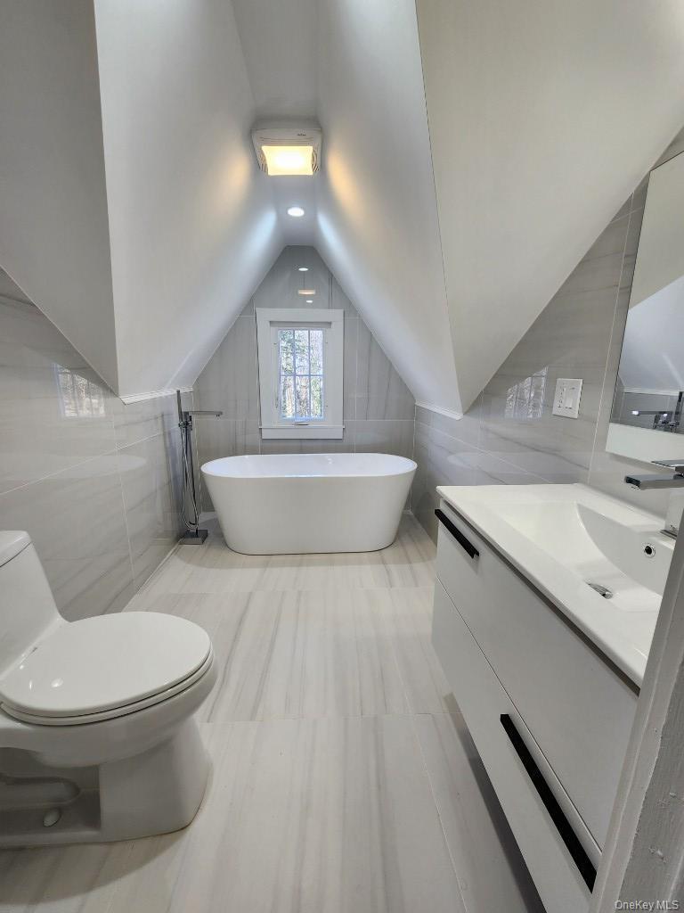 20 North Ravine Road Kings Point, NY 11023 - Photo 33 of 49 a bathroom with a sink a toilet and mirror