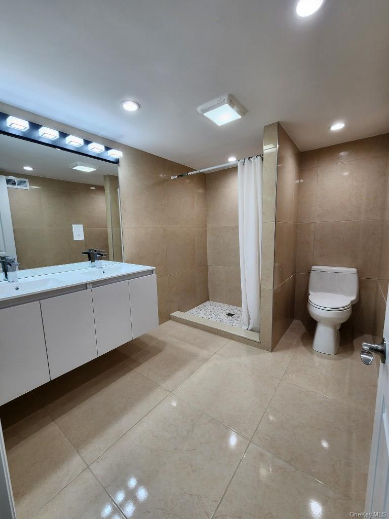 20 North Ravine Road Kings Point, NY 11023 - Photo 35 of 49 a bathroom with a sink a toilet and a mirror