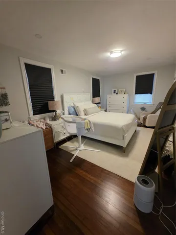 a bedroom with furniture and a flat screen tv