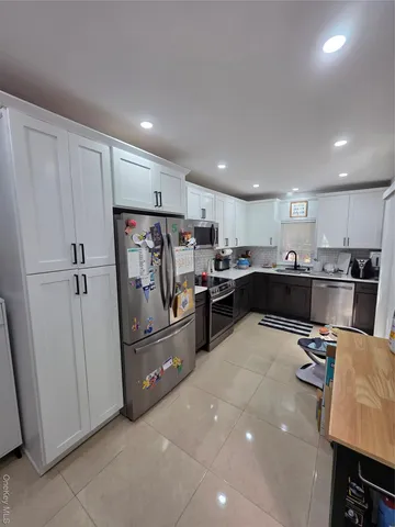 a kitchen with refrigerator and cabinets