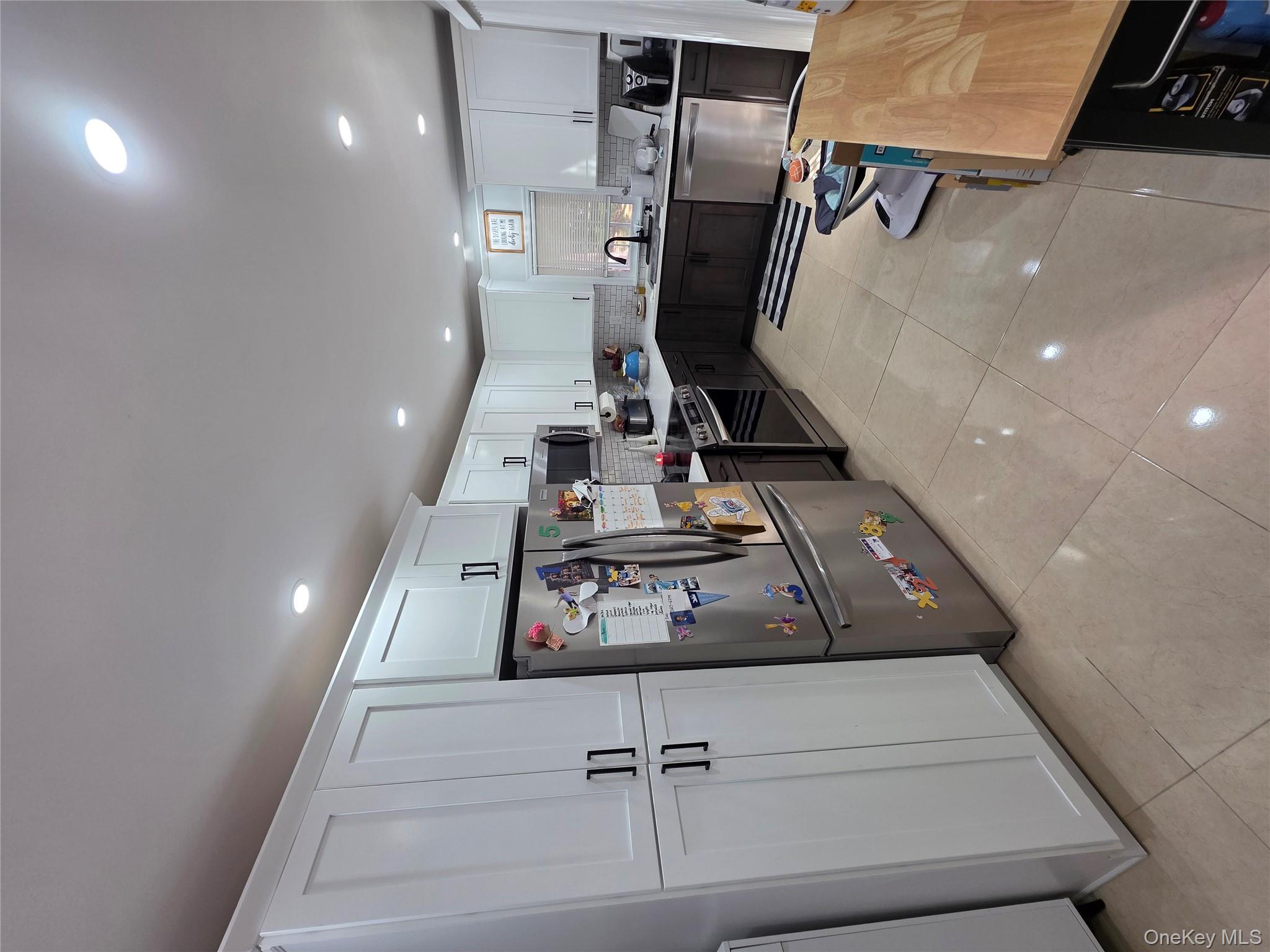 20 North Ravine Road Kings Point, NY 11023 - Photo 47 of 49 a kitchen with refrigerator and cabinets