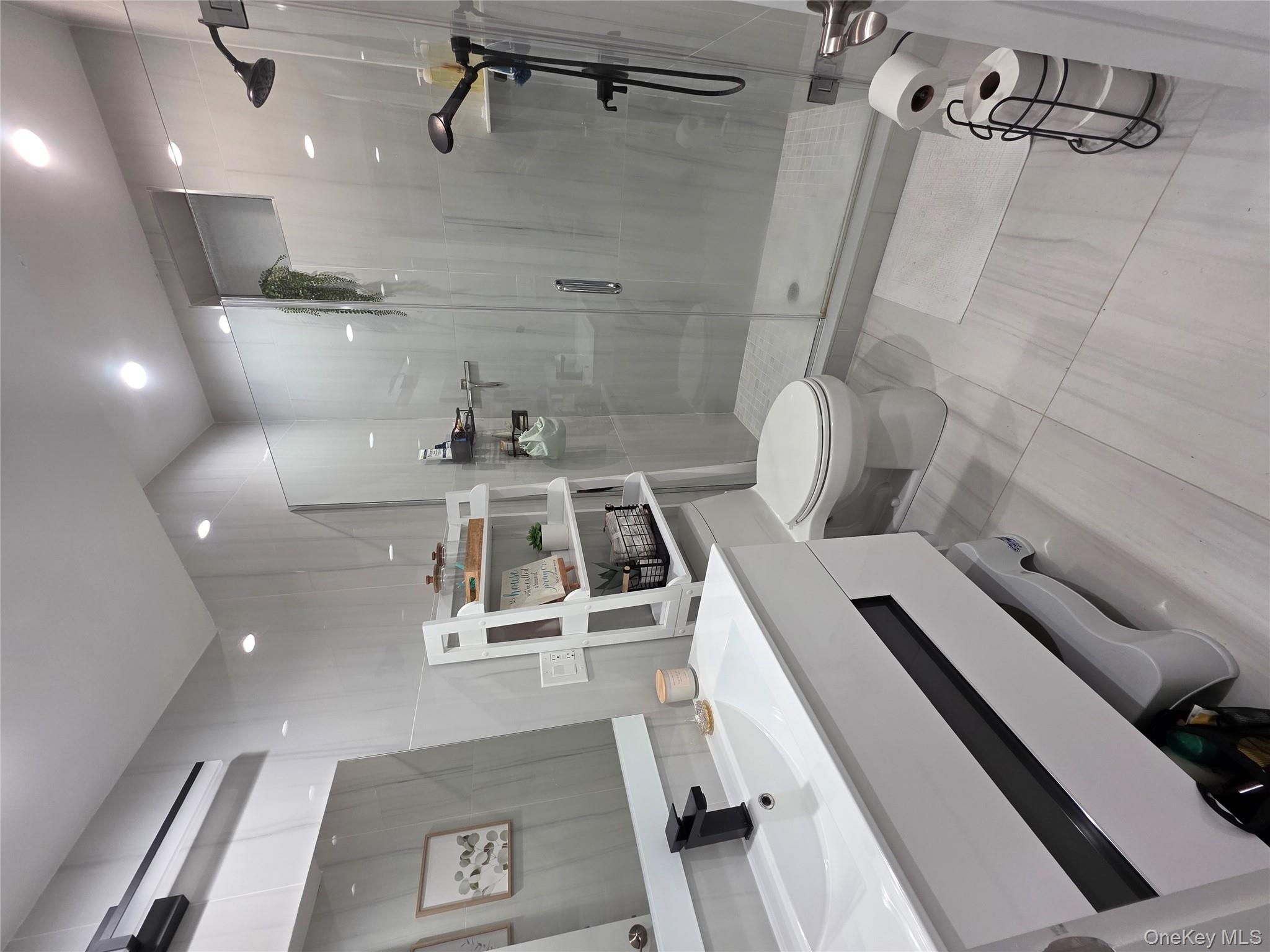 20 North Ravine Road Kings Point, NY 11023 - Photo 49 of 49 a bathroom with a sink a toilet a mirror and shower