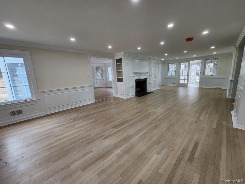 20 North Ravine Road Kings Point, NY 11023 - Photo 6 of 49 an empty room with wooden floor and windows