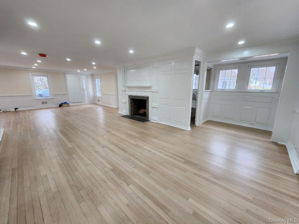 20 North Ravine Road Kings Point, NY 11023 - Photo 7 of 49 an empty room with wooden floor and windows