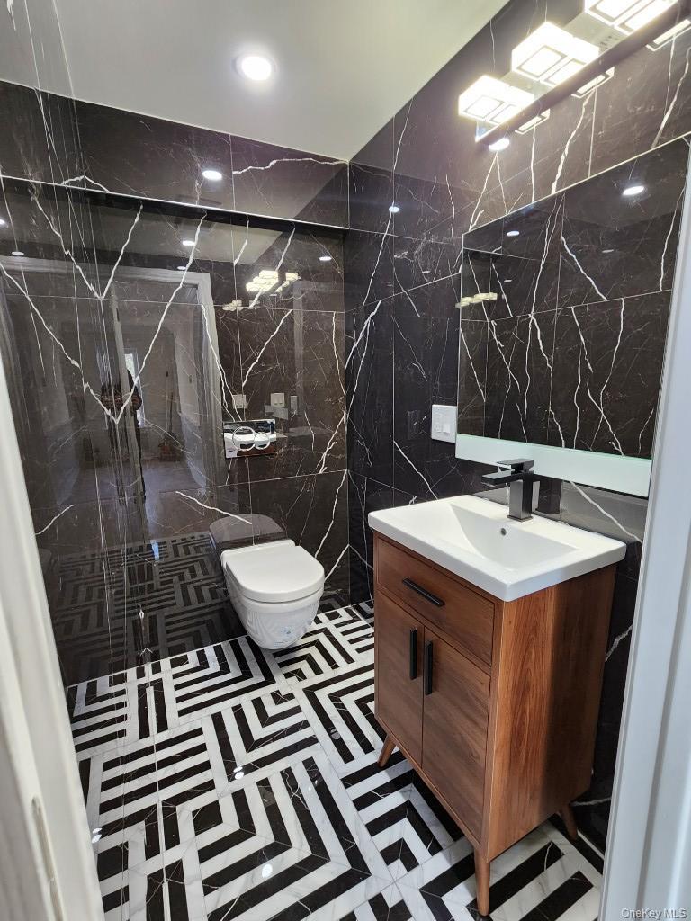 20 North Ravine Road Kings Point, NY 11023 - Photo 8 of 49 a bathroom with a sink and a mirror