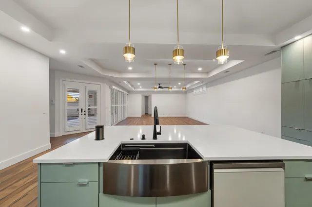 a kitchen with stainless steel appliances granite countertop a sink and a refrigerator