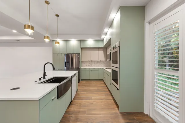 a view of empty room with wooden floor and windows