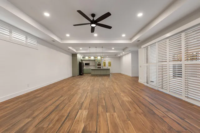 a view of empty room with wooden floor and window