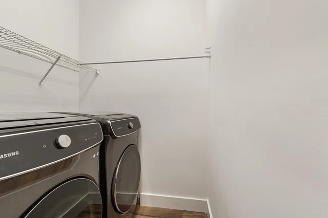 an aerial view of a house with a garden and lake view