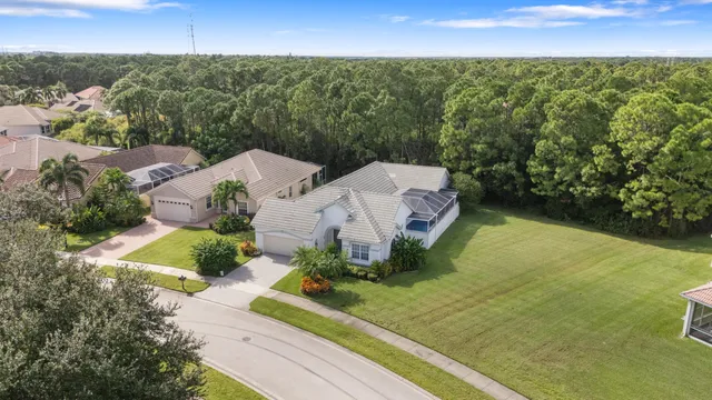 an aerial view of a house with a garden and lake view