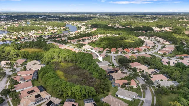 an aerial view of lake and residential houses with outdoor space