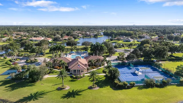 an aerial view of residential houses with outdoor space and swimming pool