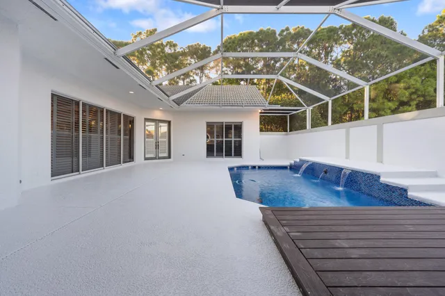 a large kitchen with kitchen island a island wooden floor stainless steel appliances and cabinets