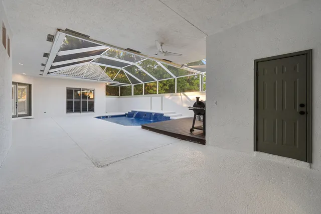 a kitchen with a sink a counter and chairs