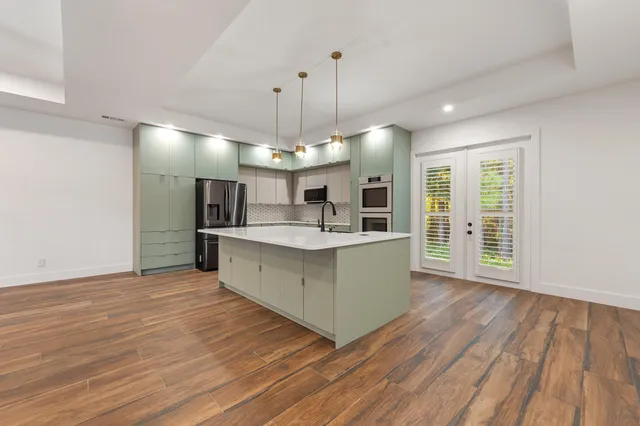 a kitchen with stainless steel appliances granite countertop a sink and a microwave