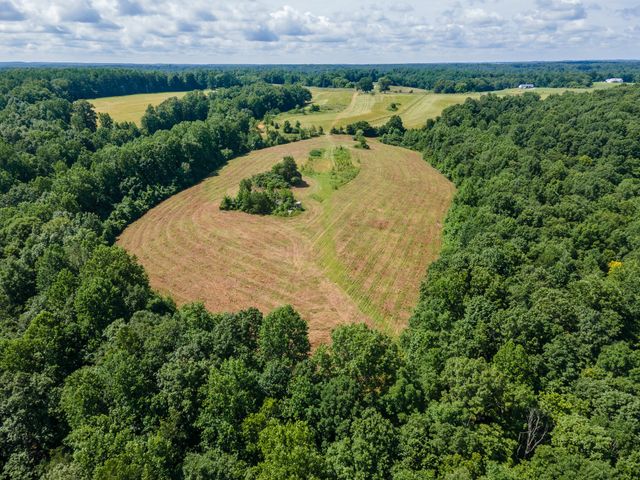 an aerial view of a house with a yard and lake view