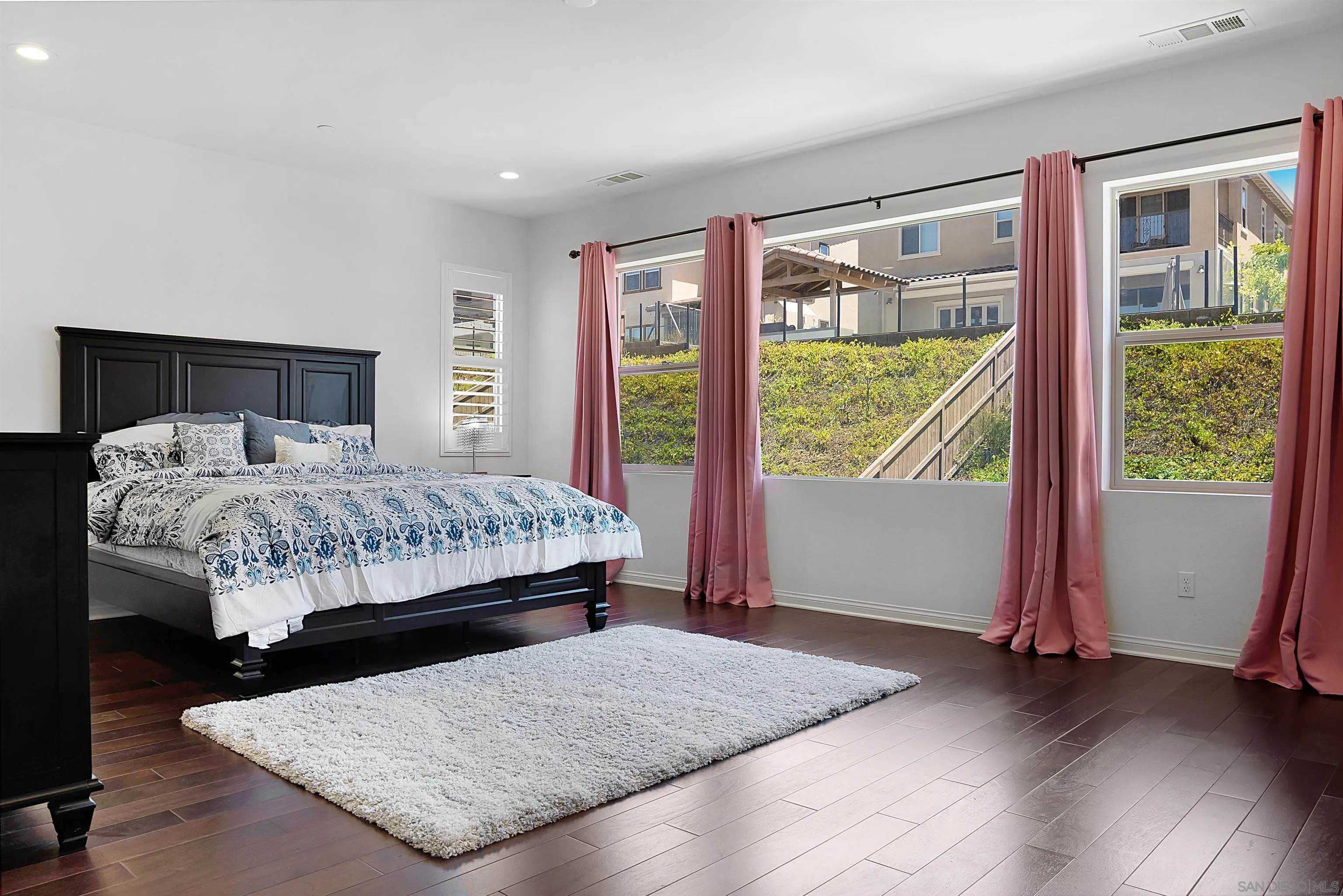 15901 Sarah Ridge Road San Diego, CA 92127 - Photo 16 of 34 a bedroom with a bed and wooden floor