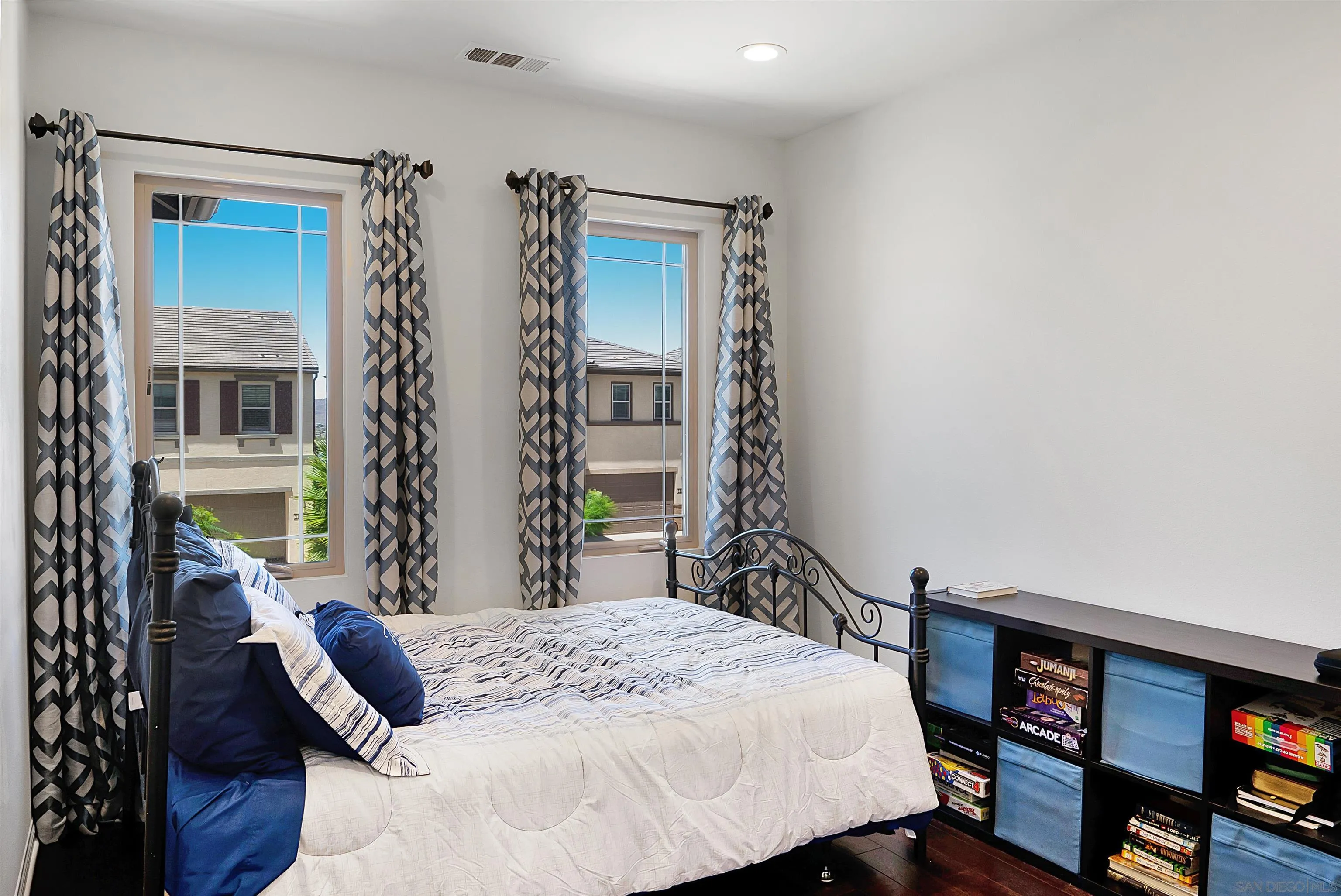 15901 Sarah Ridge Road San Diego, CA 92127 - Photo 18 of 34 a bedroom with a bed a couch and a bookshelf