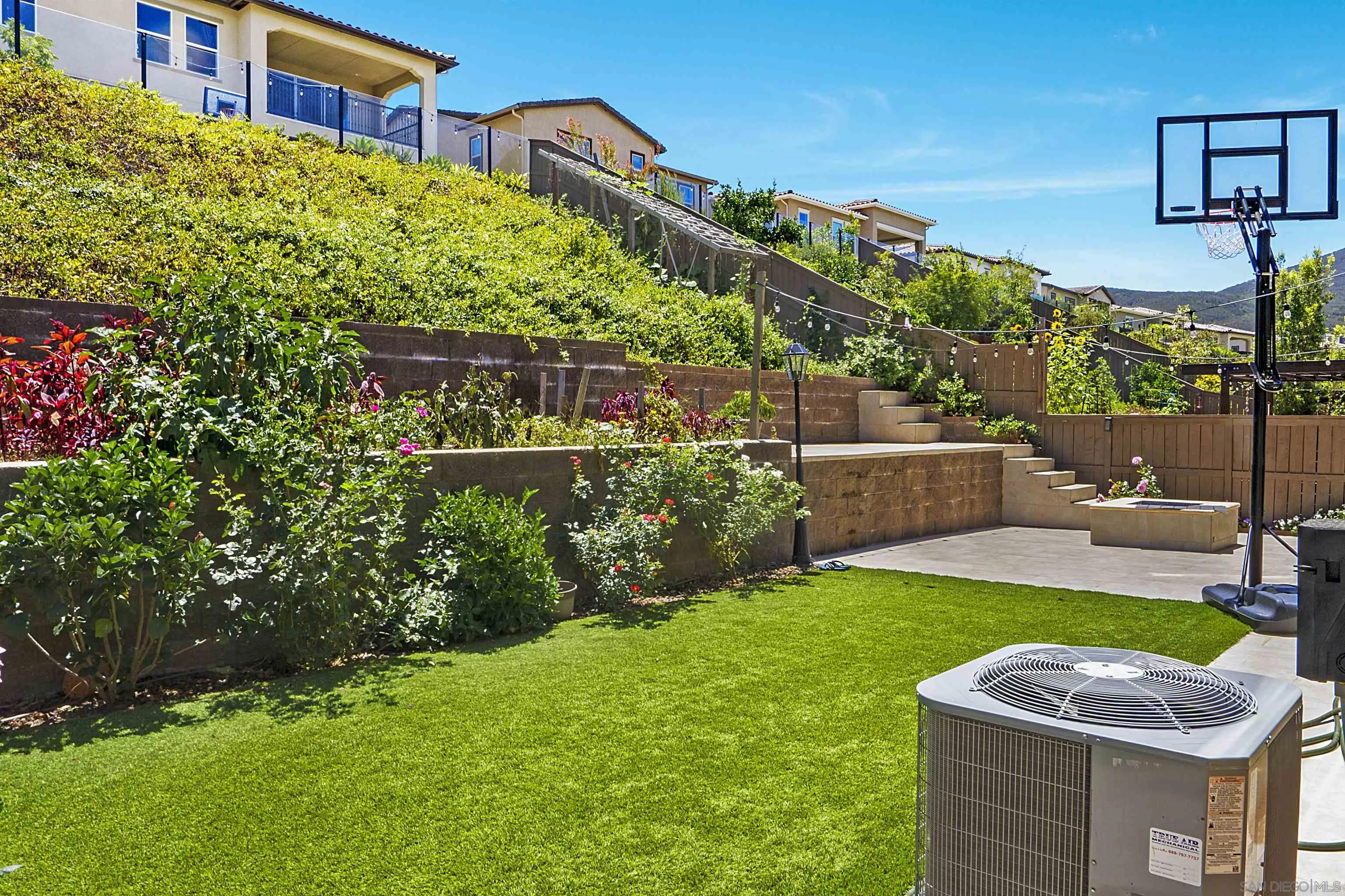 15901 Sarah Ridge Road San Diego, CA 92127 - Photo 33 of 34 a backyard of a house with lots of green space and glass windows