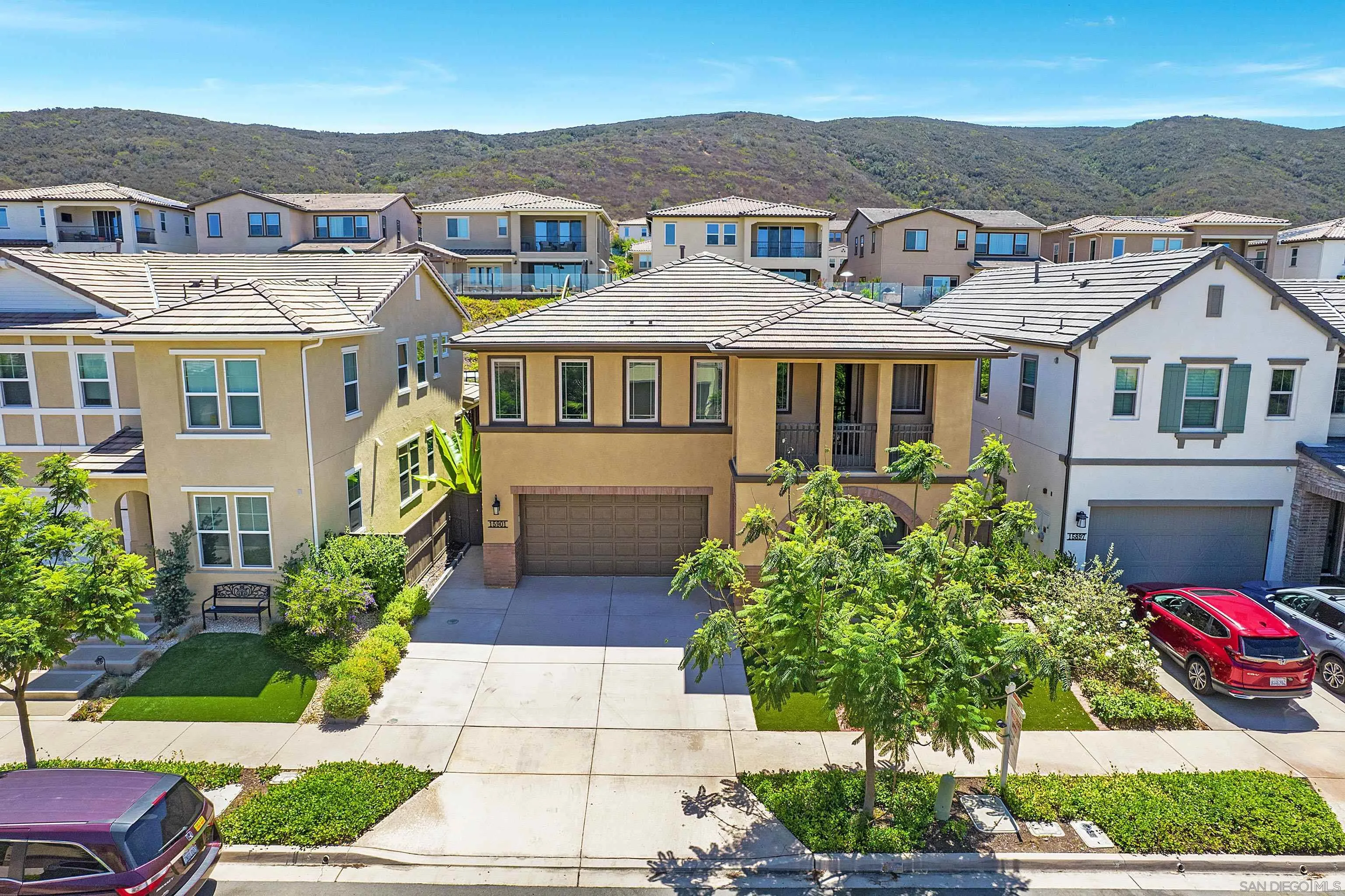 15901 Sarah Ridge Road San Diego, CA 92127 - Photo 5 of 34 a front view of a house with a yard and potted plants