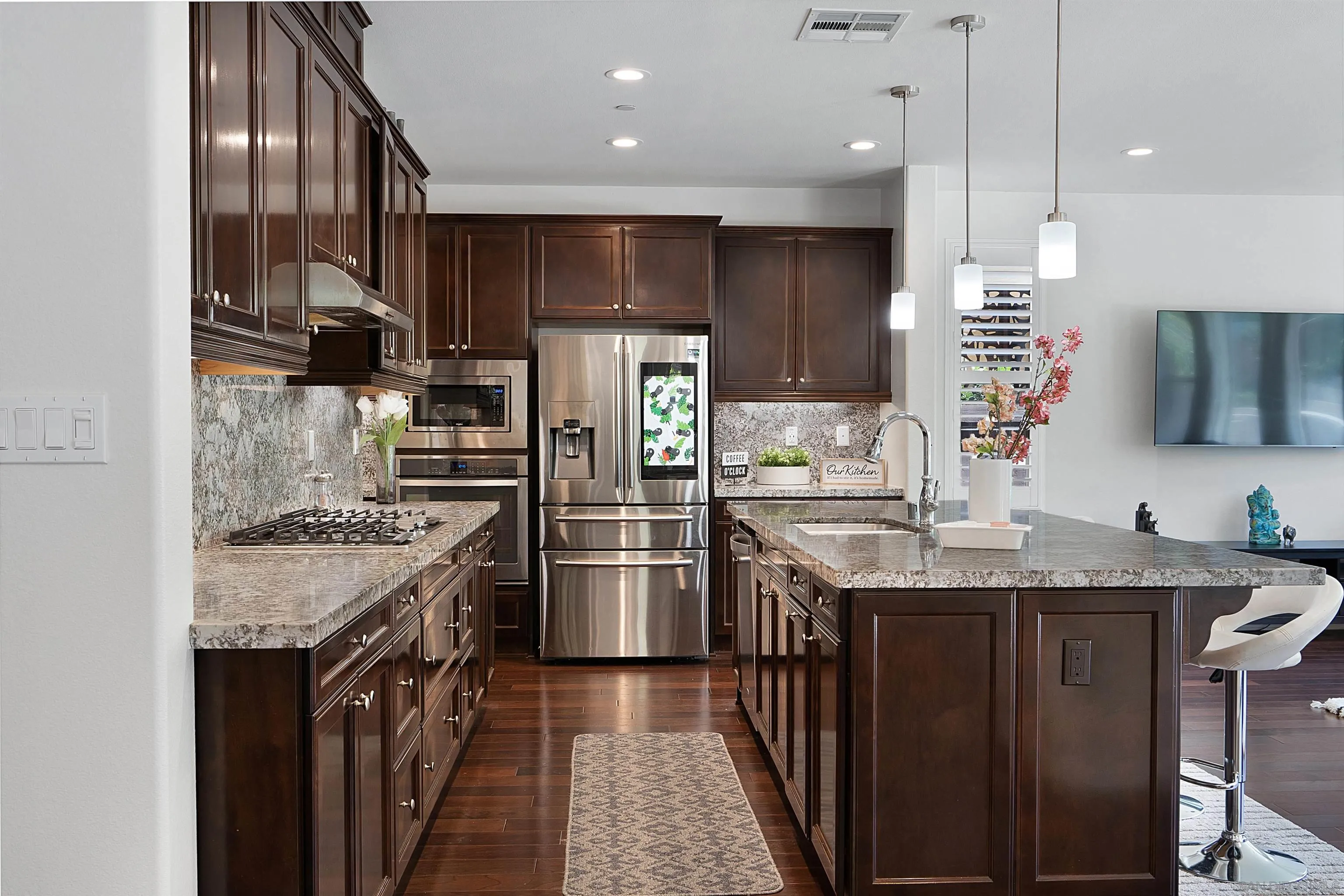 15901 Sarah Ridge Road San Diego, CA 92127 - Photo 6 of 34 a kitchen with stainless steel appliances granite countertop a sink stove and refrigerator