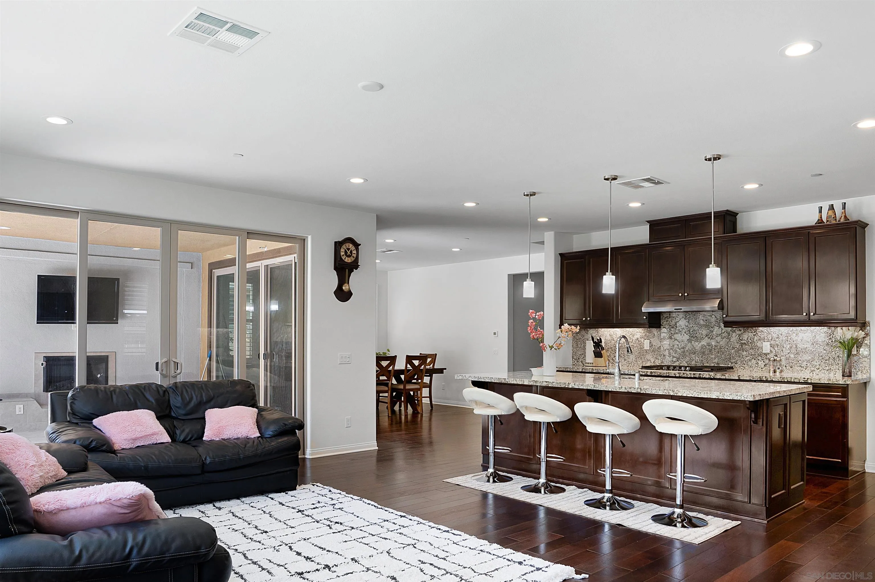 15901 Sarah Ridge Road San Diego, CA 92127 - Photo 7 of 34 a living room with stainless steel appliances kitchen island granite countertop furniture and a view of kitchen