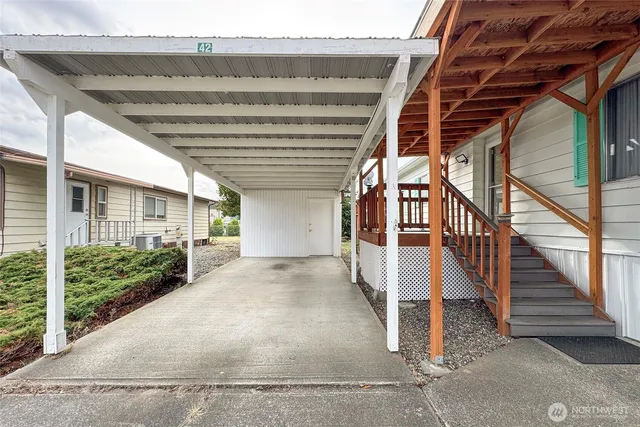 a view of a chairs and table in backyard of the house