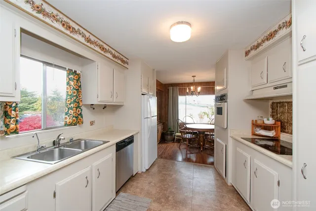 a kitchen with a sink cabinets and window