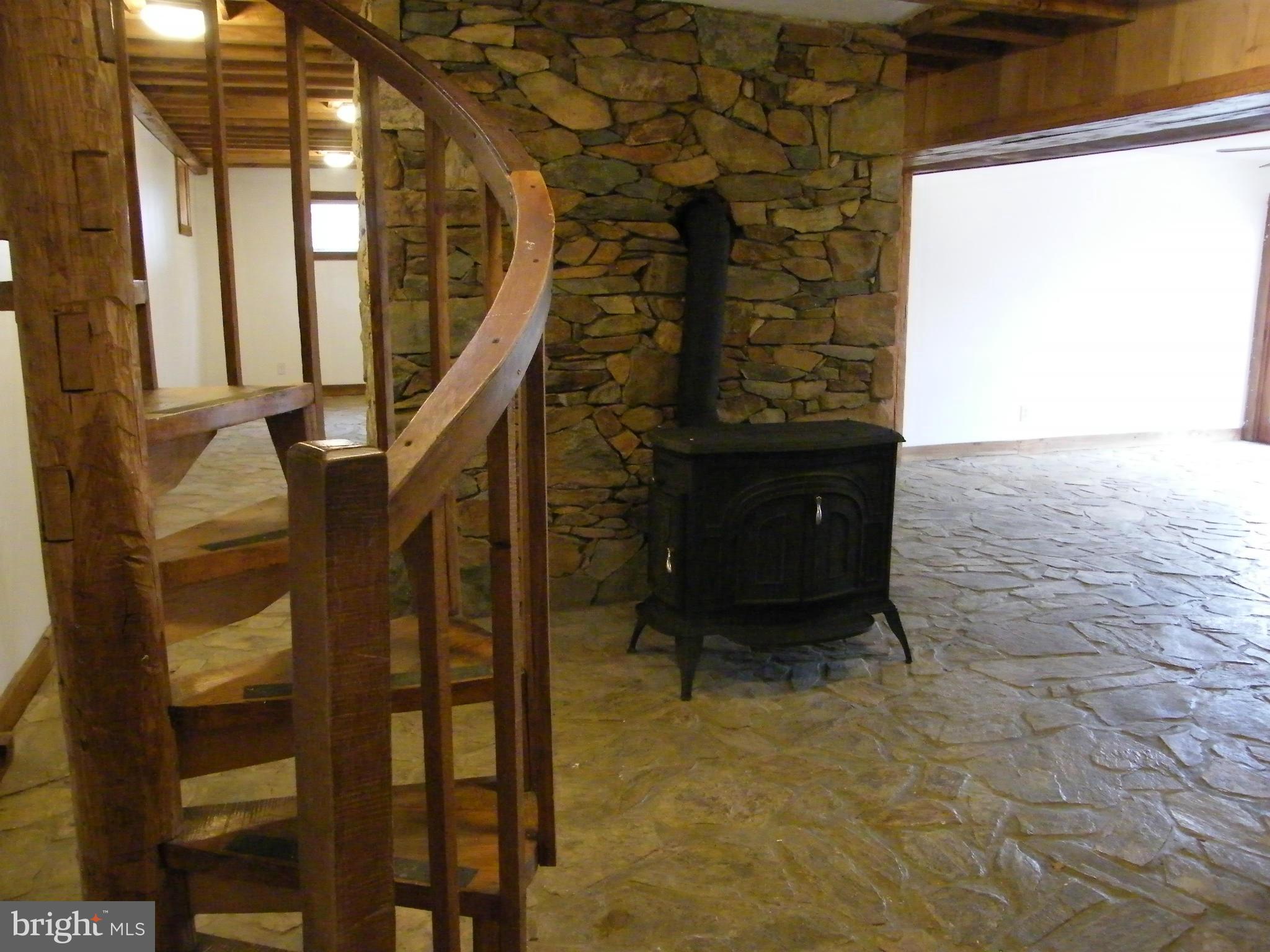 13261 Wilt Store Road Leesburg, VA 20176 - Photo 20 of 30 Spiral Staircase to LL Family Rm/ wood stove