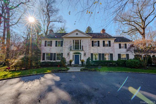 10 Hidden Pond Muttontown, NY 11545 - Photo 1 of 46 a front view of a house with garden
