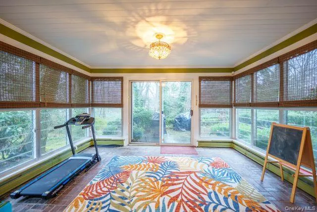 a bedroom with furniture and large windows