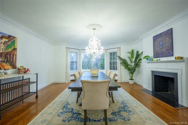 a dining room with furniture window and wooden floor