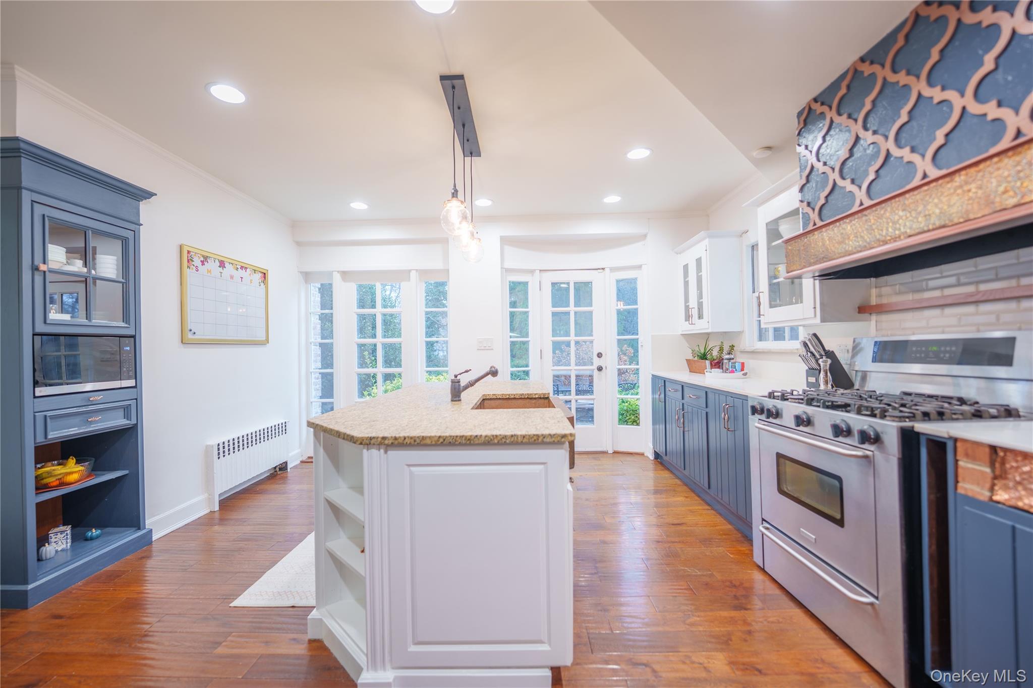 10 Hidden Pond Muttontown, NY 11545 - Photo 18 of 46 a kitchen with stainless steel appliances granite countertop a sink a stove and a wooden floors