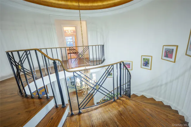 a view of staircase with white walls and railing