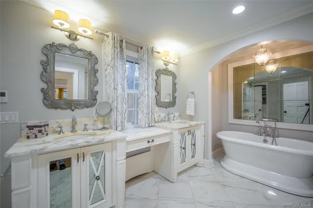 a bathroom with a double vanity sink mirror and a bathtub