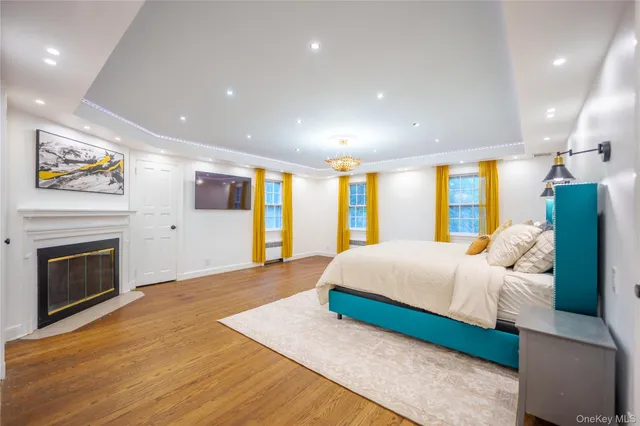 a spacious bedroom with a large bed and a fireplace