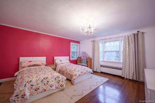 10 Hidden Pond Muttontown, NY 11545 - Photo 29 of 46 Oversized bedroom with a chandelier, crown molding, dark wood flooring, and jack and jill bath entrance