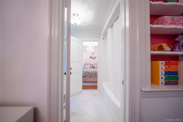 a view of a hallway with wooden floor and furniture
