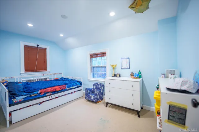 a bedroom with bed and a window