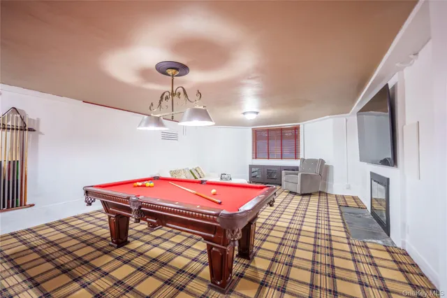 a room with furniture and pool table