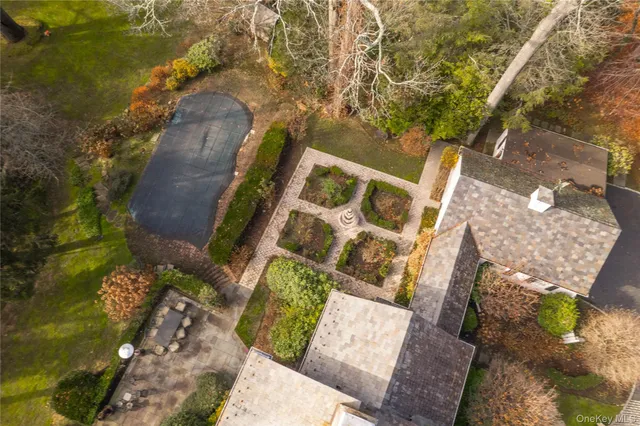 an aerial view of a house with a yard and wooden fence